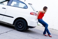 woman pushing car